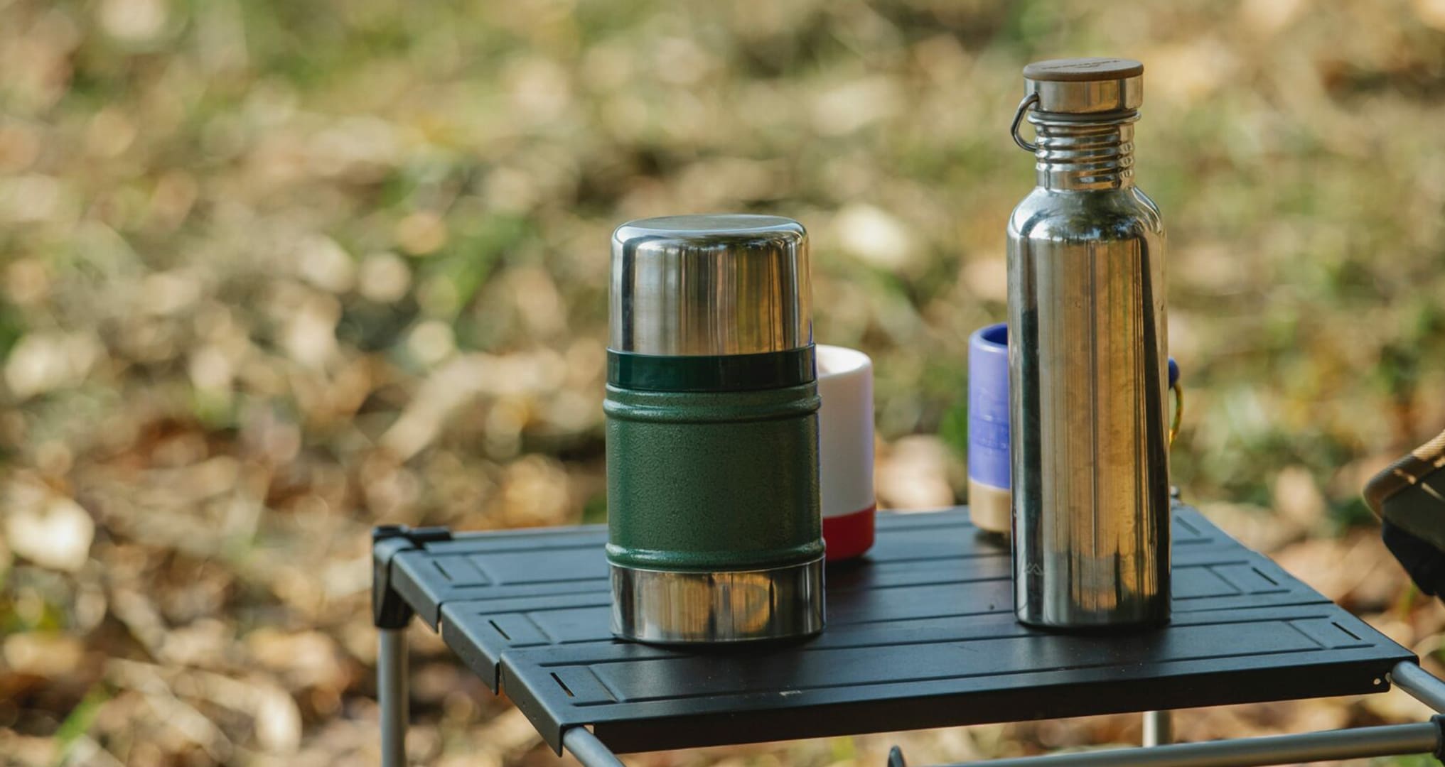 reusable water bottles on camping table