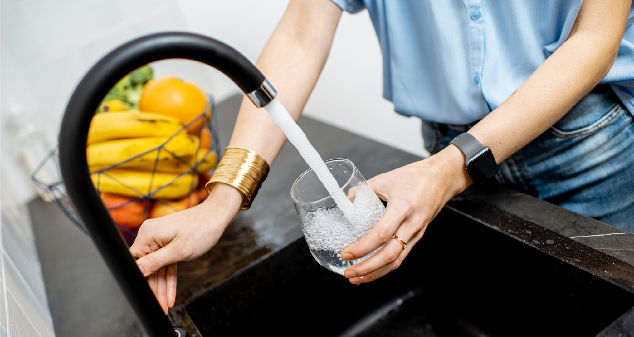 Woman refilling cup with RO water