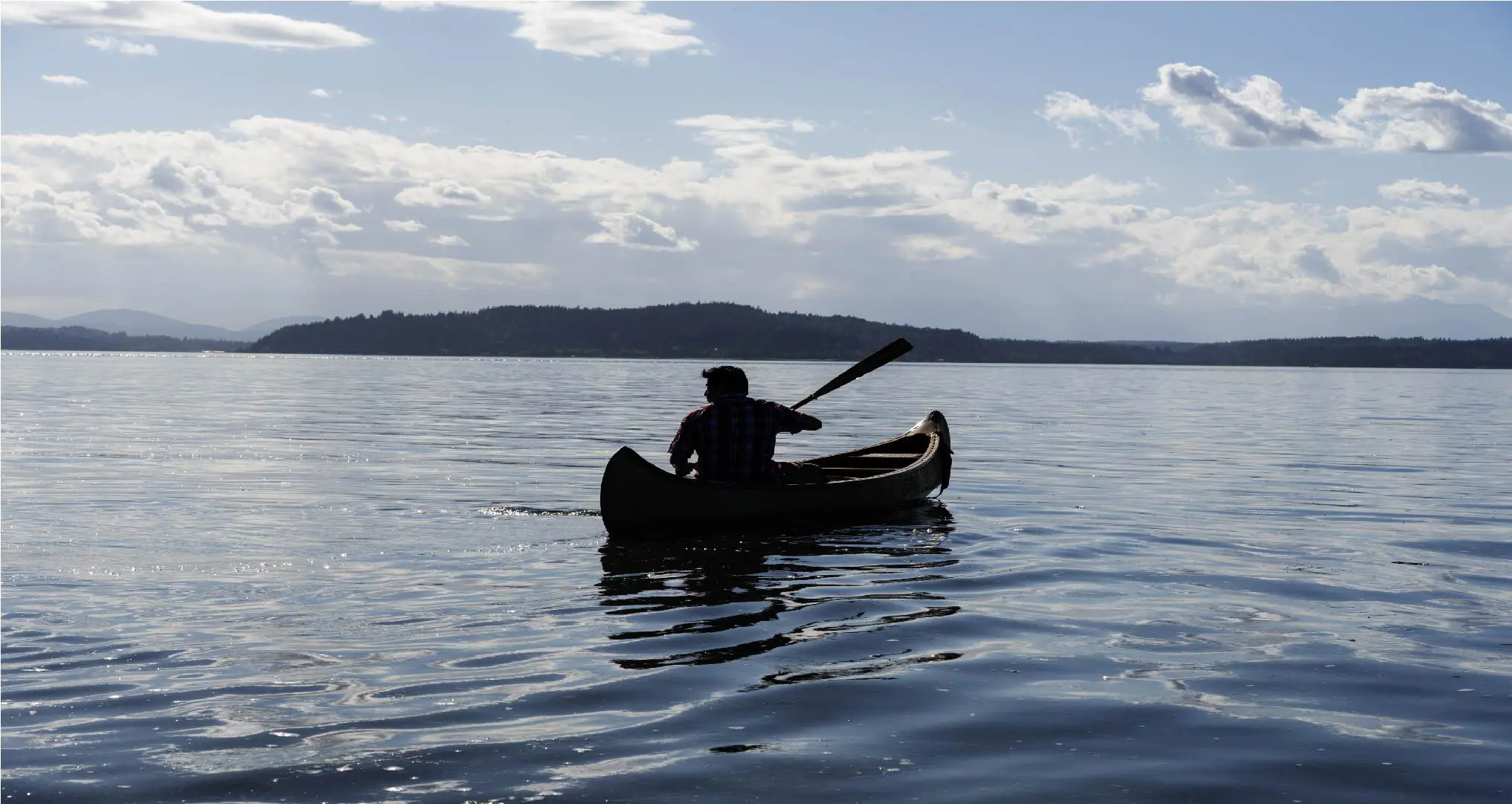 native-american-canoe-paddling-out-to-distant