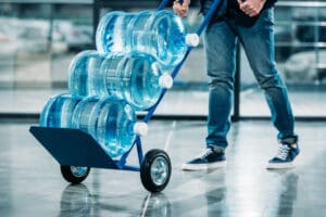 oader pushing cart with water bottles