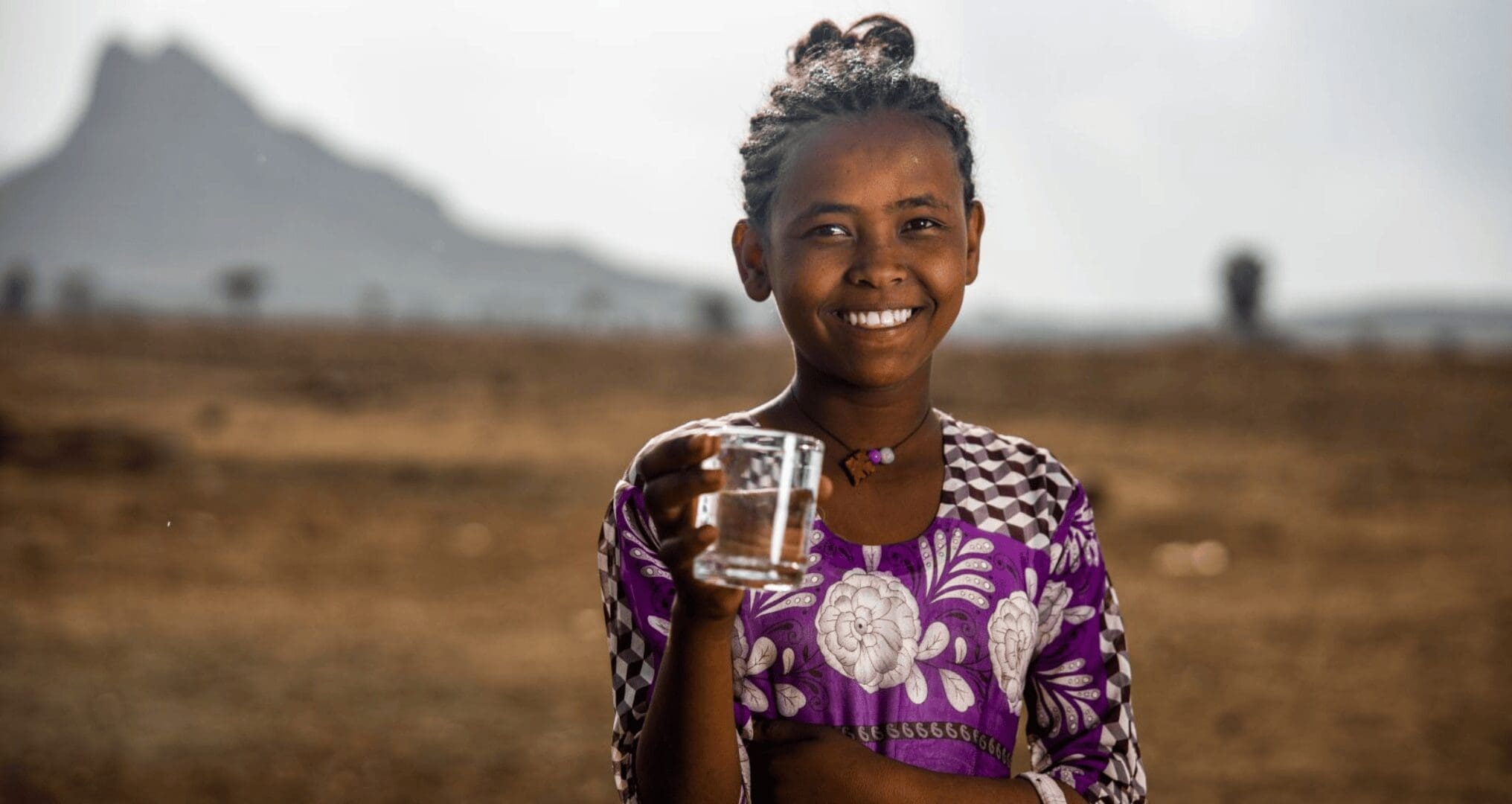 kid holding a glass of clean drinking water