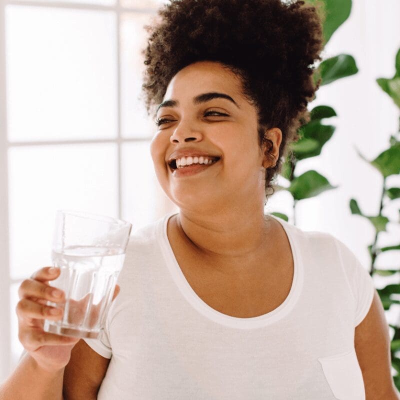 african-american woman at the office holding a glass of water