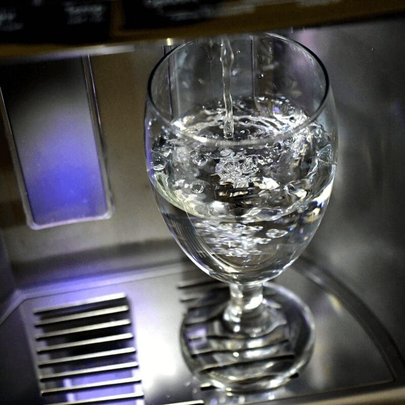 glass getting filled with water under spout