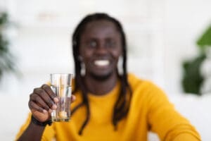 Man holding clean class of drinking water